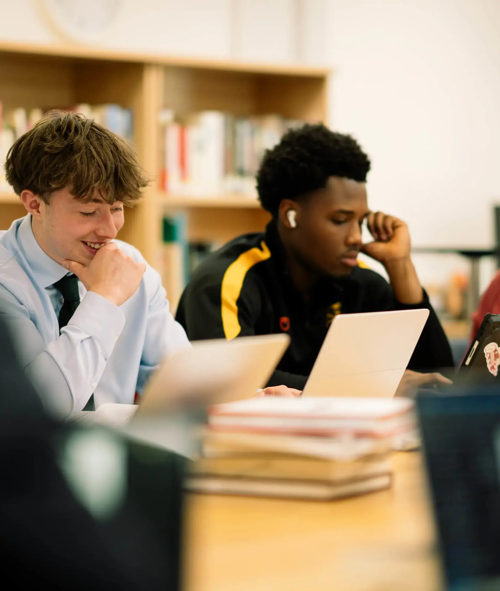 Students reading textbooks in the library