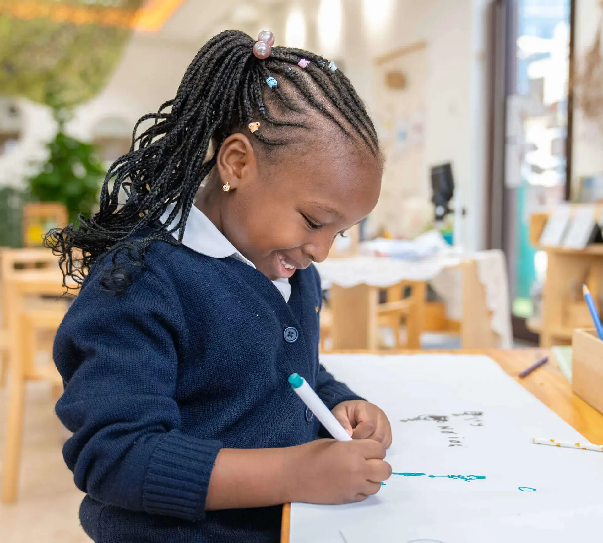 Student writing on whiteboard on desk