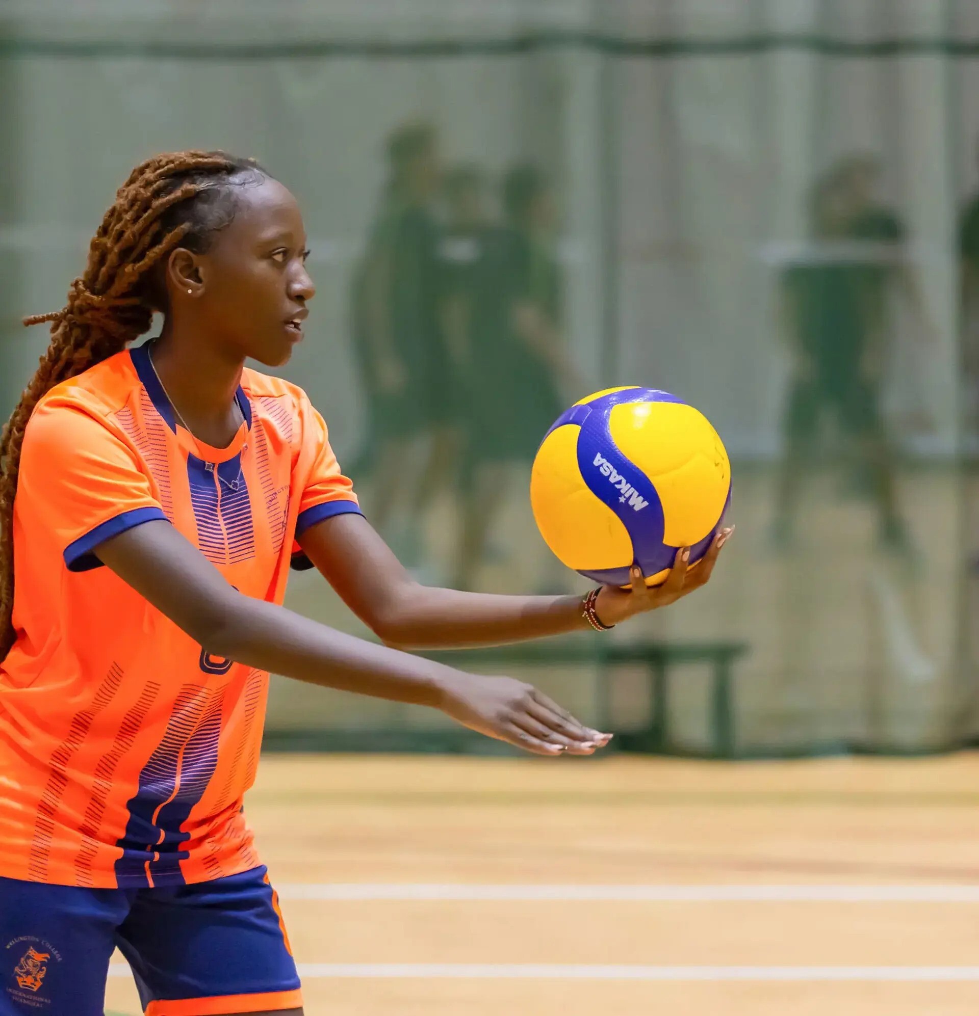 Student getting ready to serve in game of volleyball